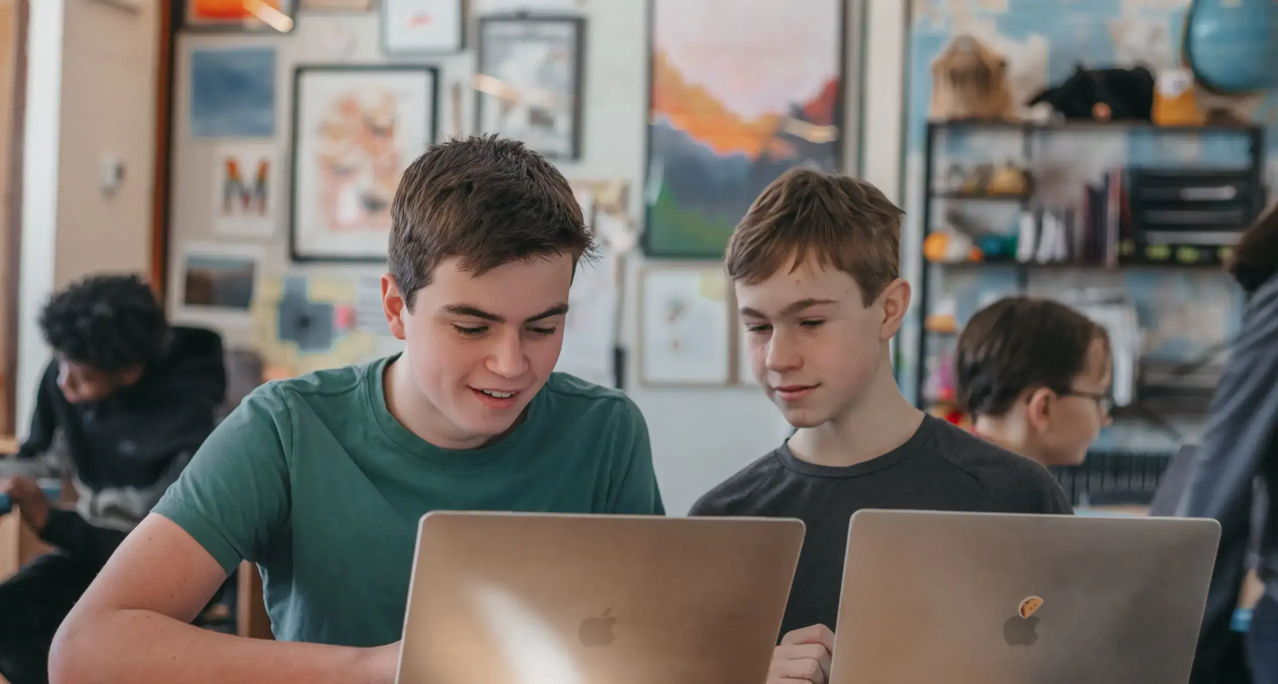 Students collaborating on a project using laptops