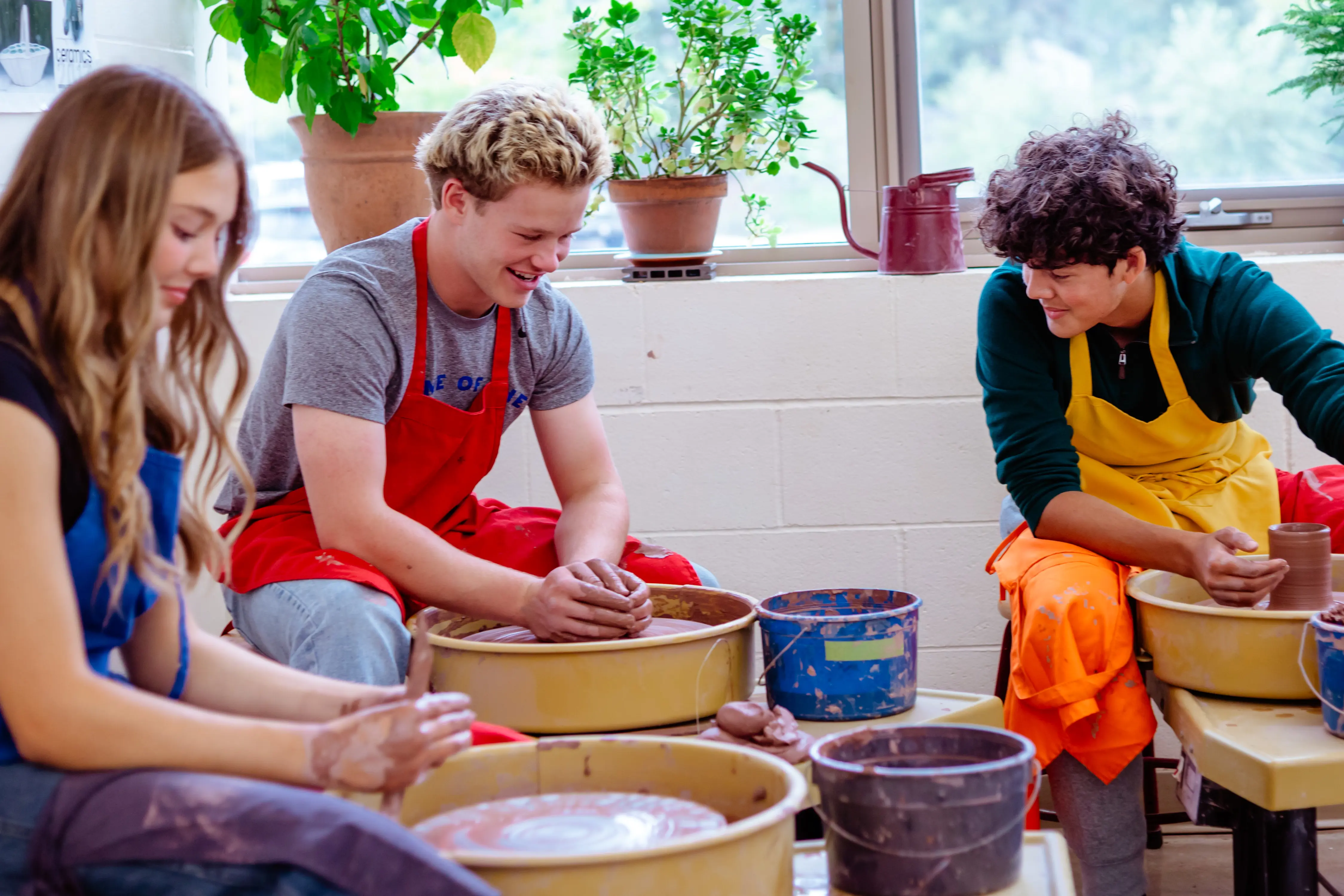 Students creating pottery in art class
