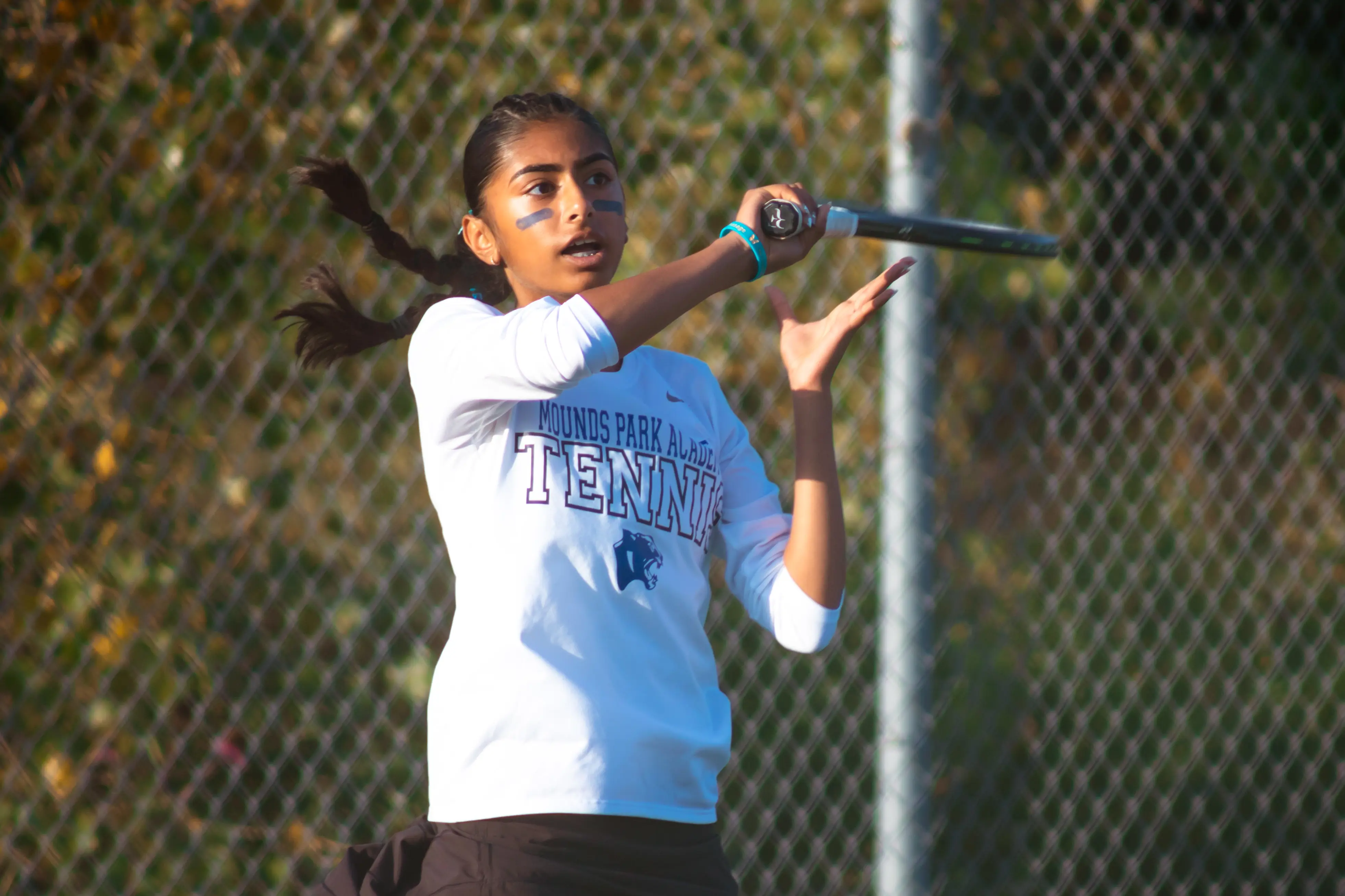 Student playing tennis