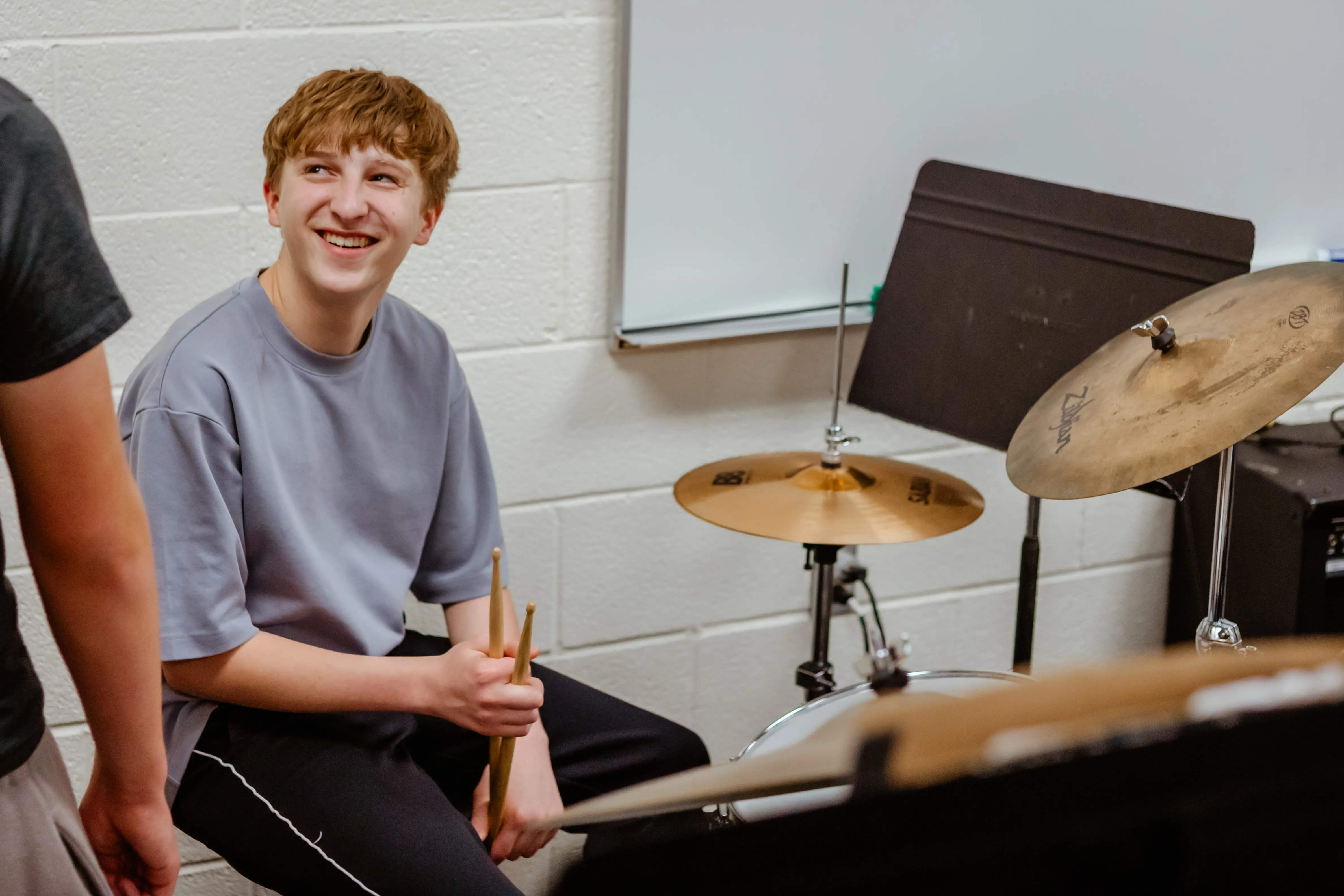 Student playing a drum set 