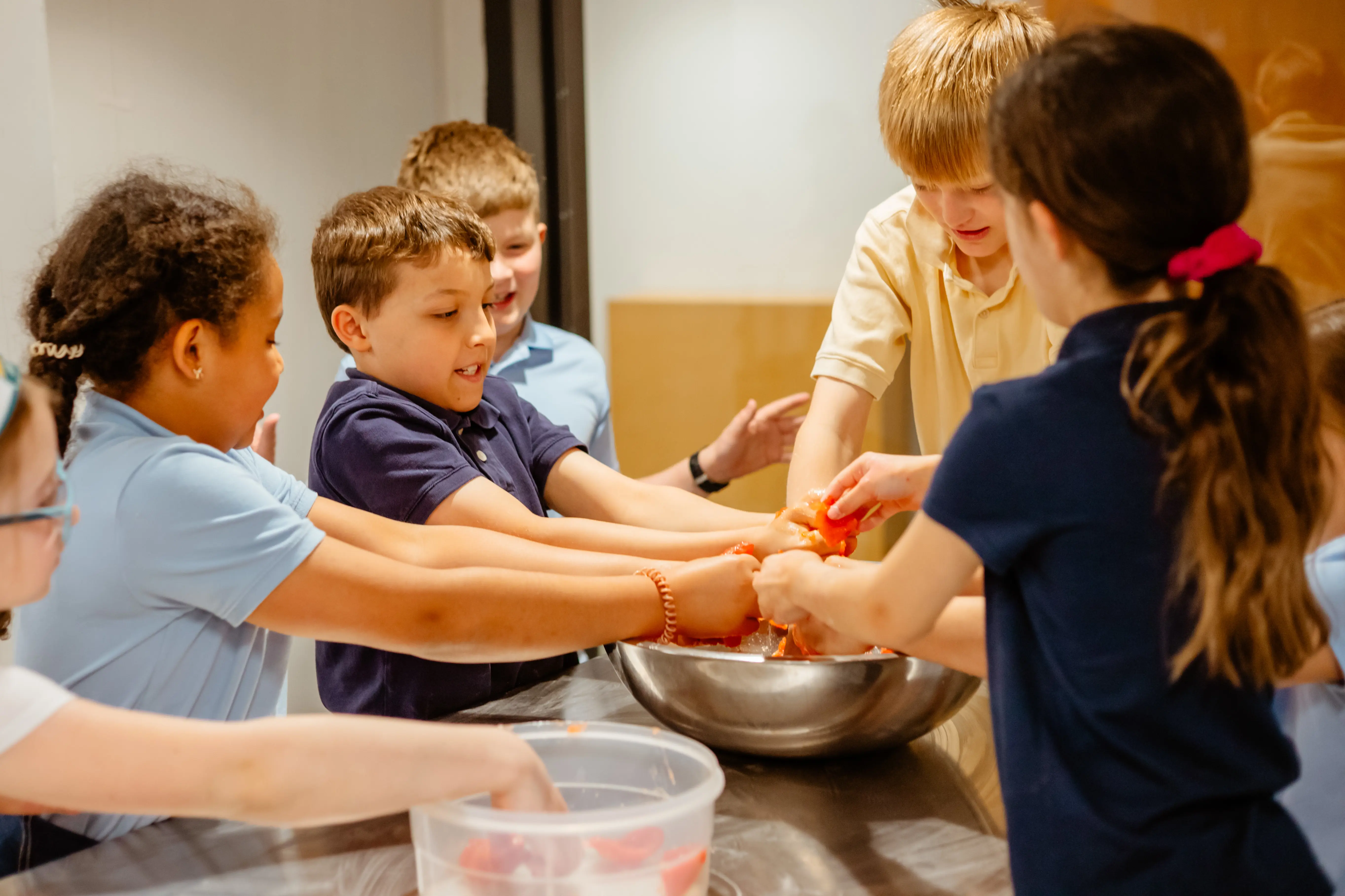 Lower school students participating in a cooking activity