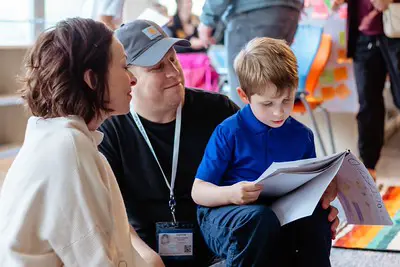 Lower School student reads story to his parents