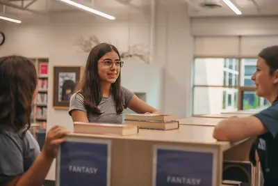 middle school students explore books in the library