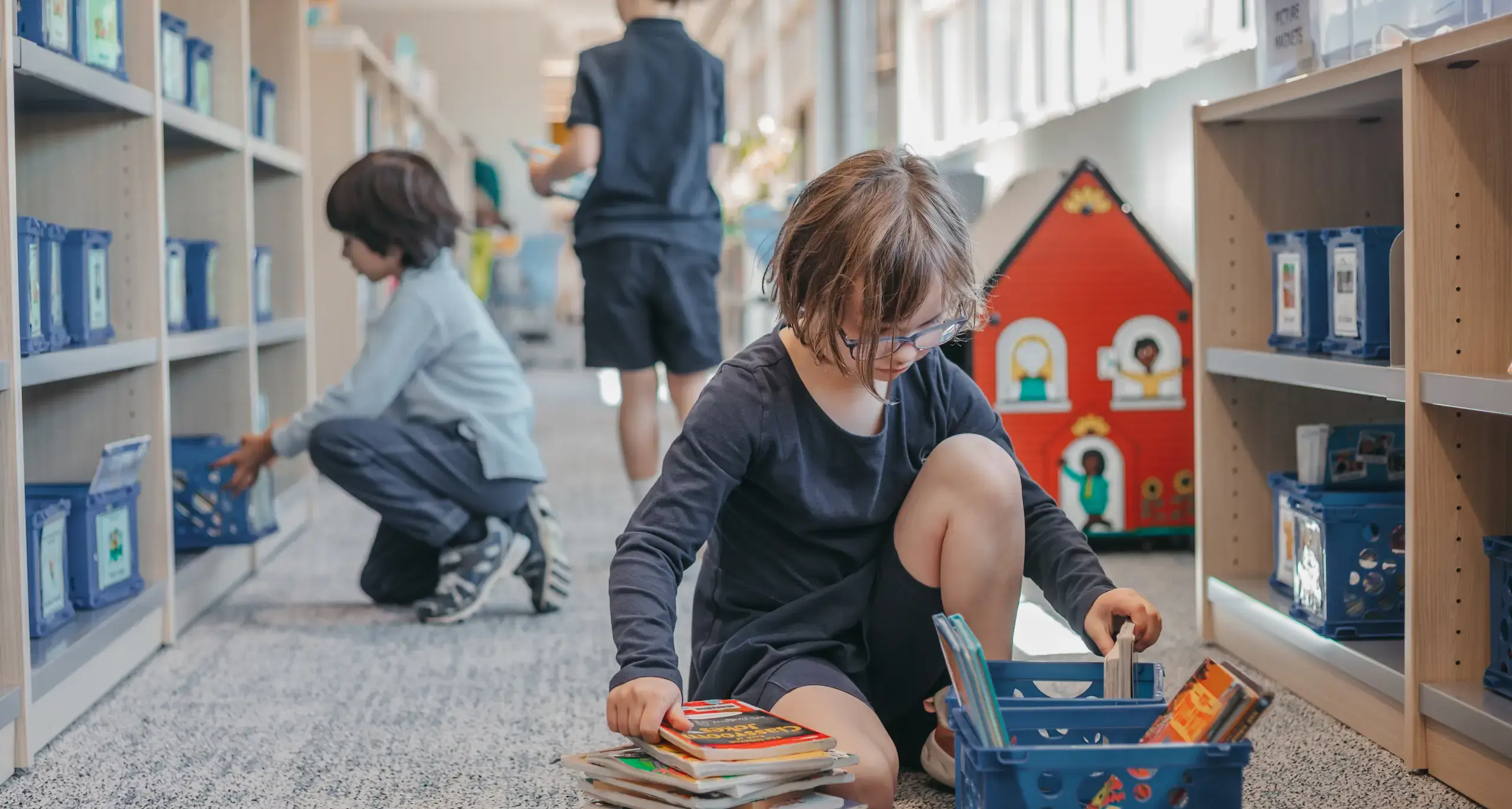 Students selecting books from the classroom library