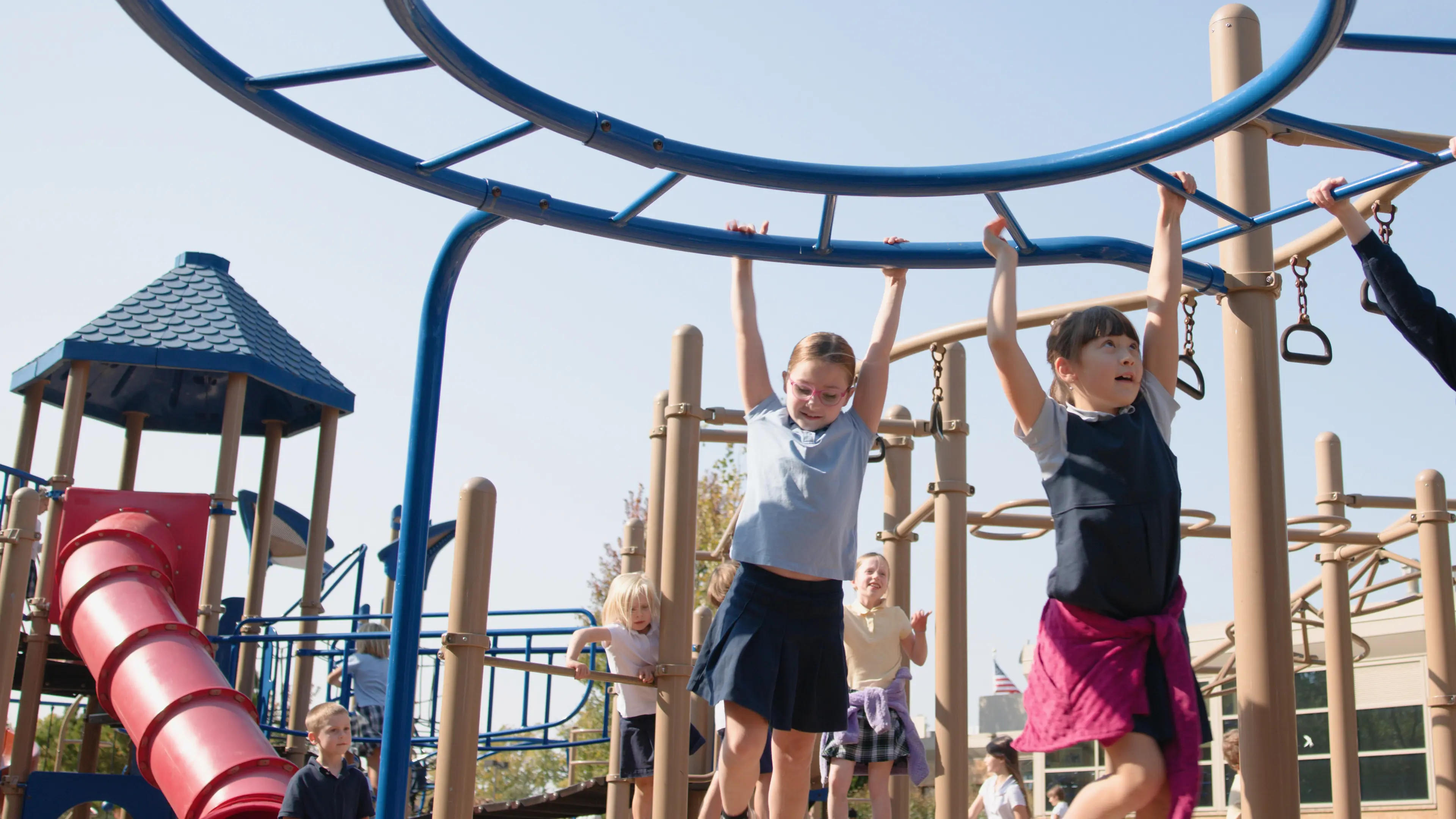 lower school students climbing the monkey bars