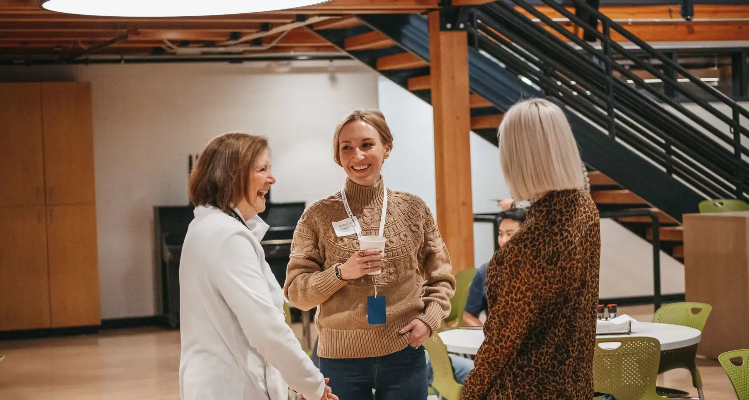 Alumni connecting at a school networking event.