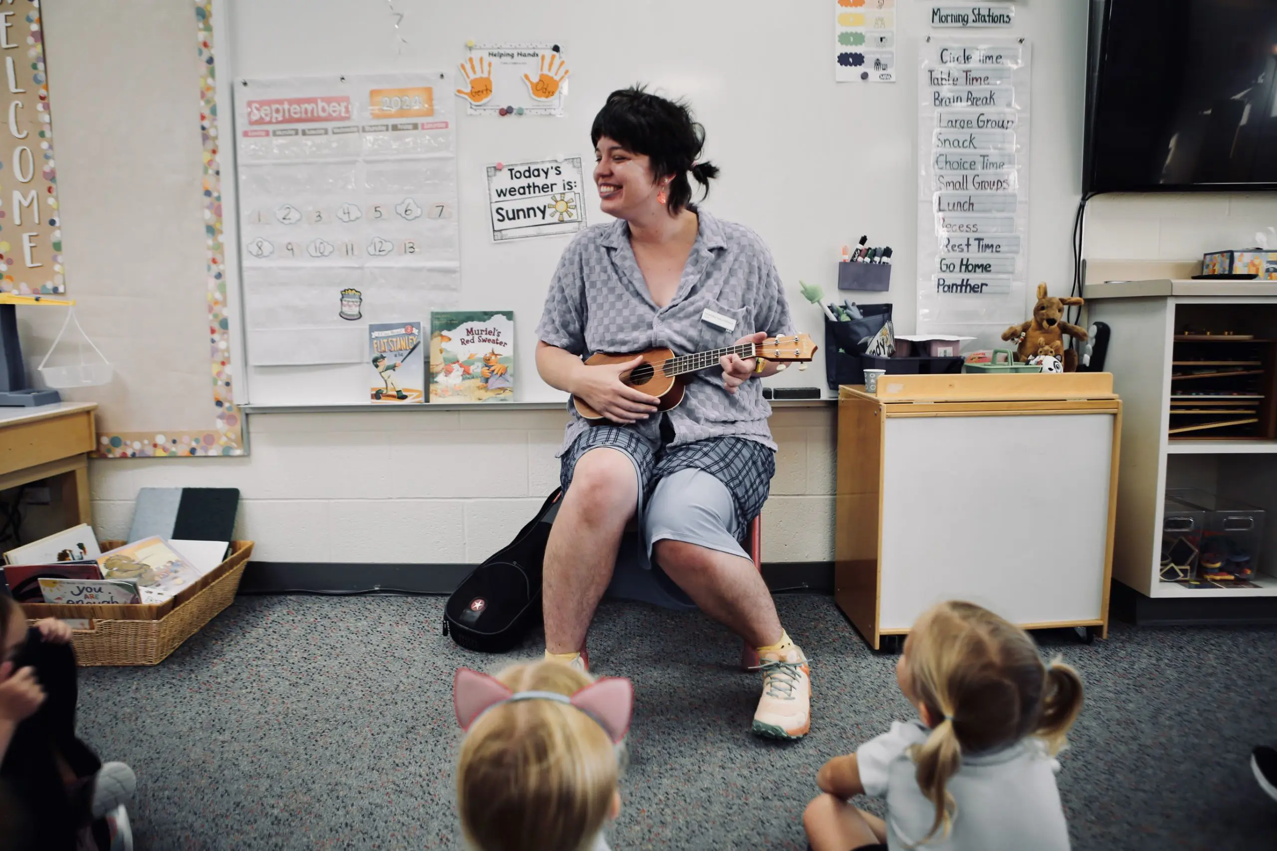 Teacher leading a music lesson with young students.