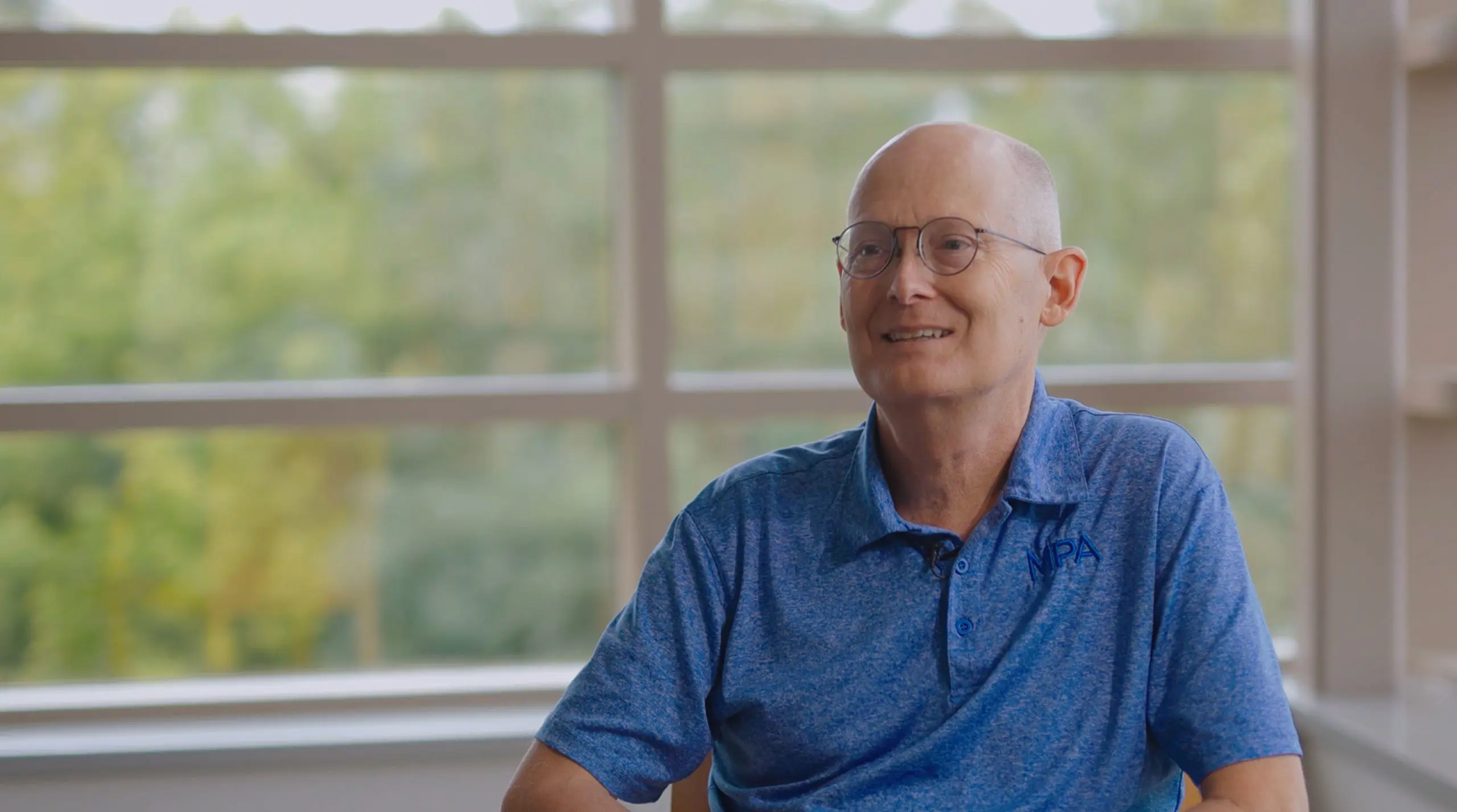 Staff member speaking during an interview.