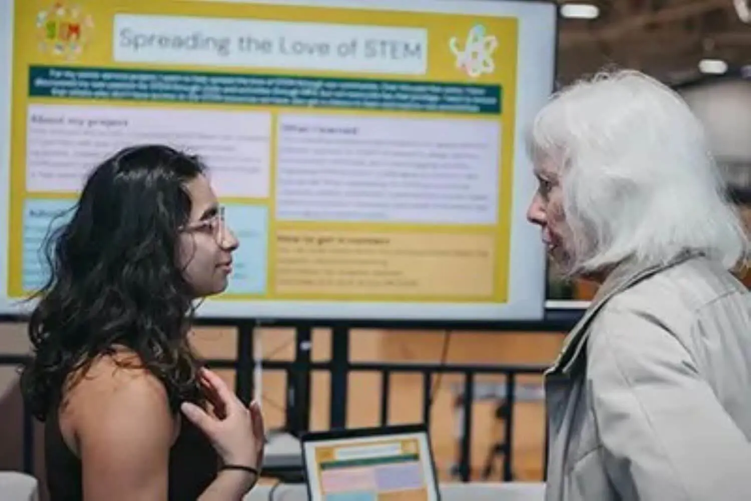 Senior explaining her senior service project to a visitor.