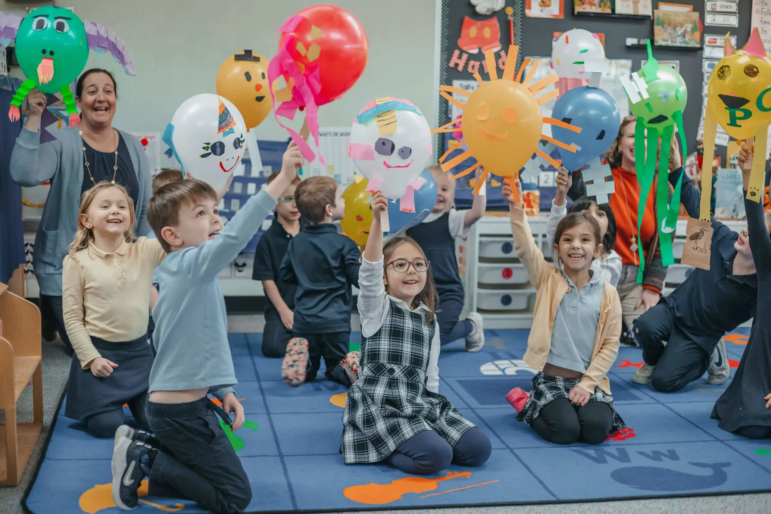 students playing decorated balloons 