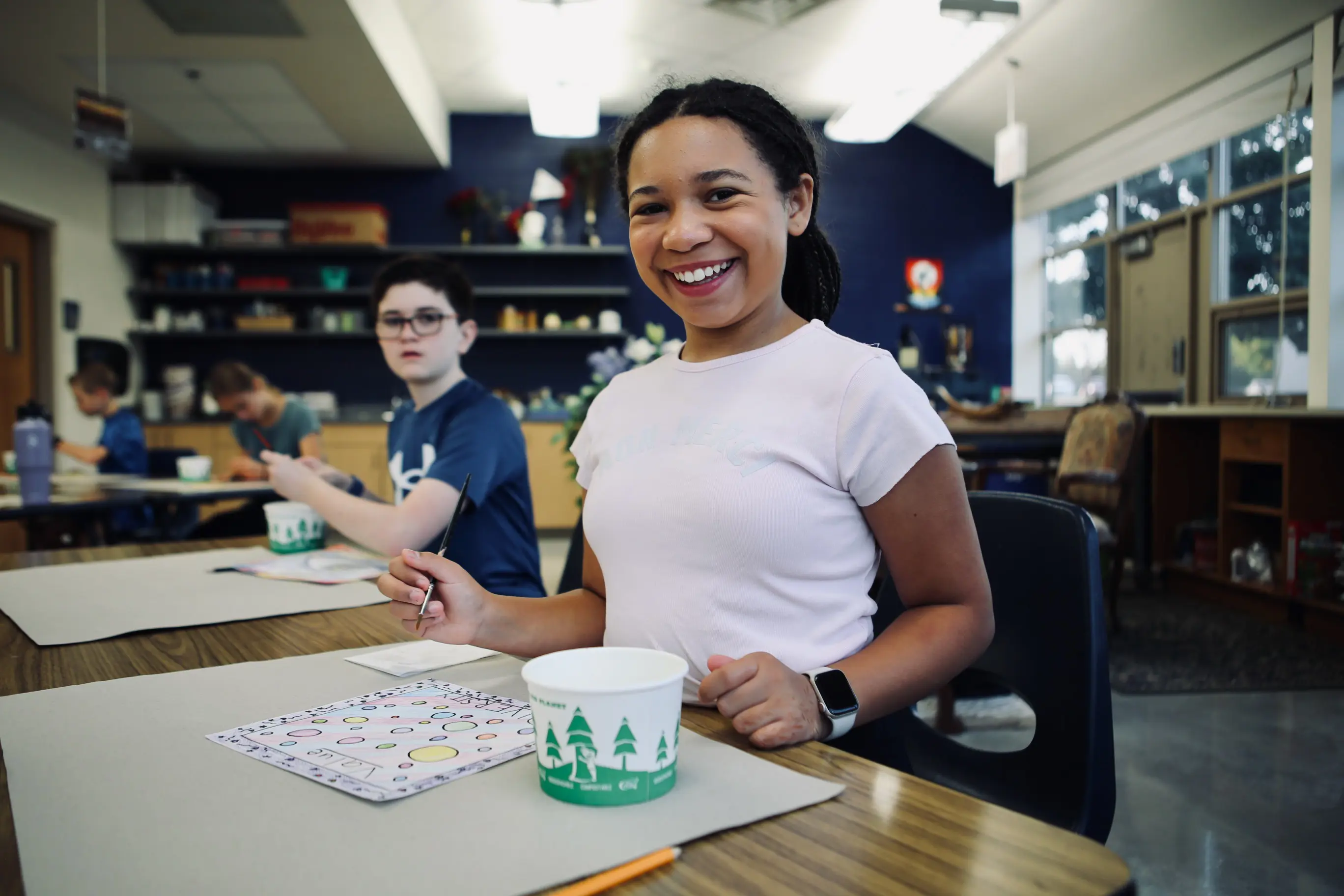 Student smiling during a classroom activity