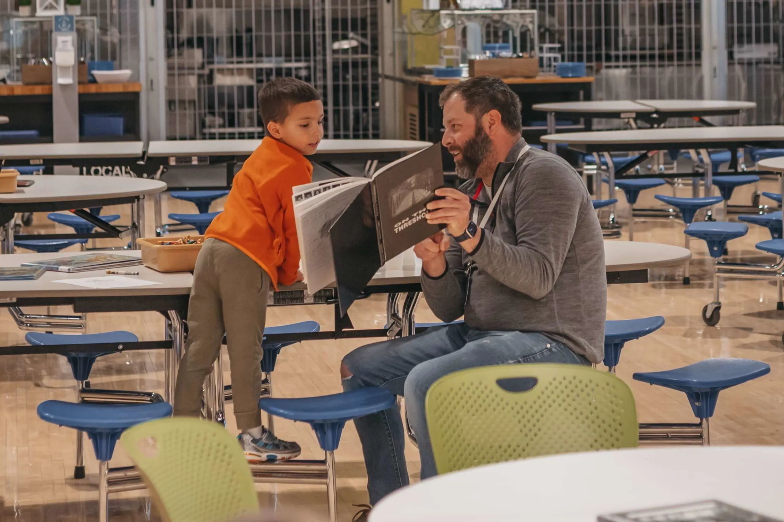 Parent reading with a lower school student.