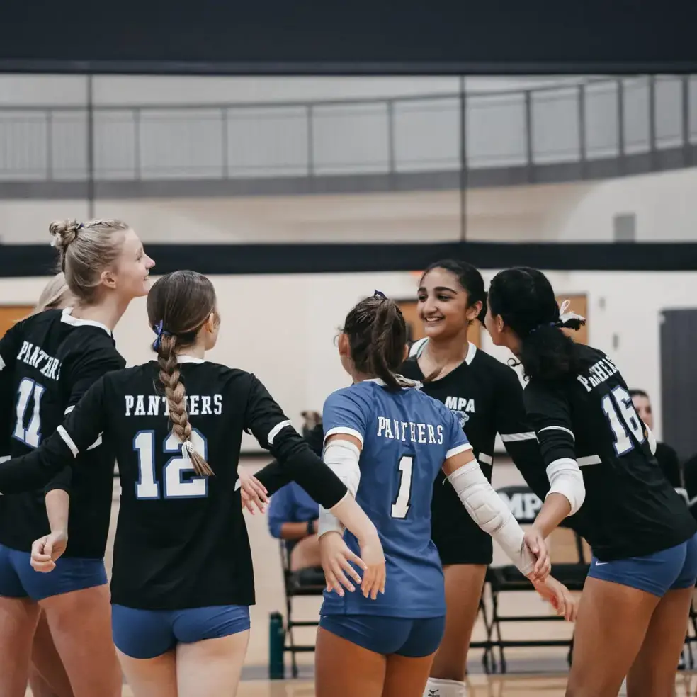 Students celebrating after a volleyball game