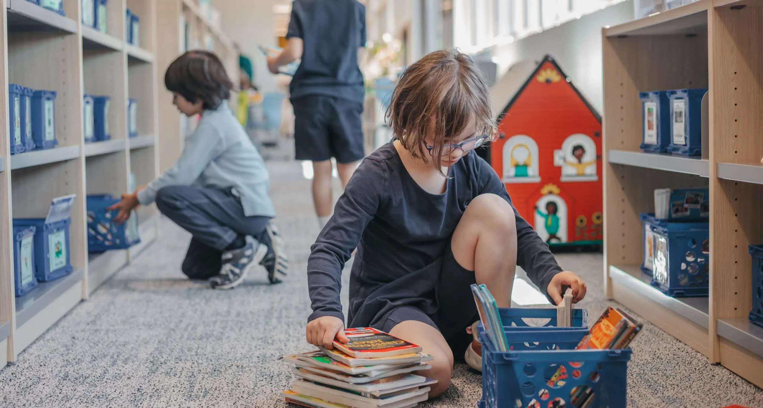 Students selecting books from the classroom library.
