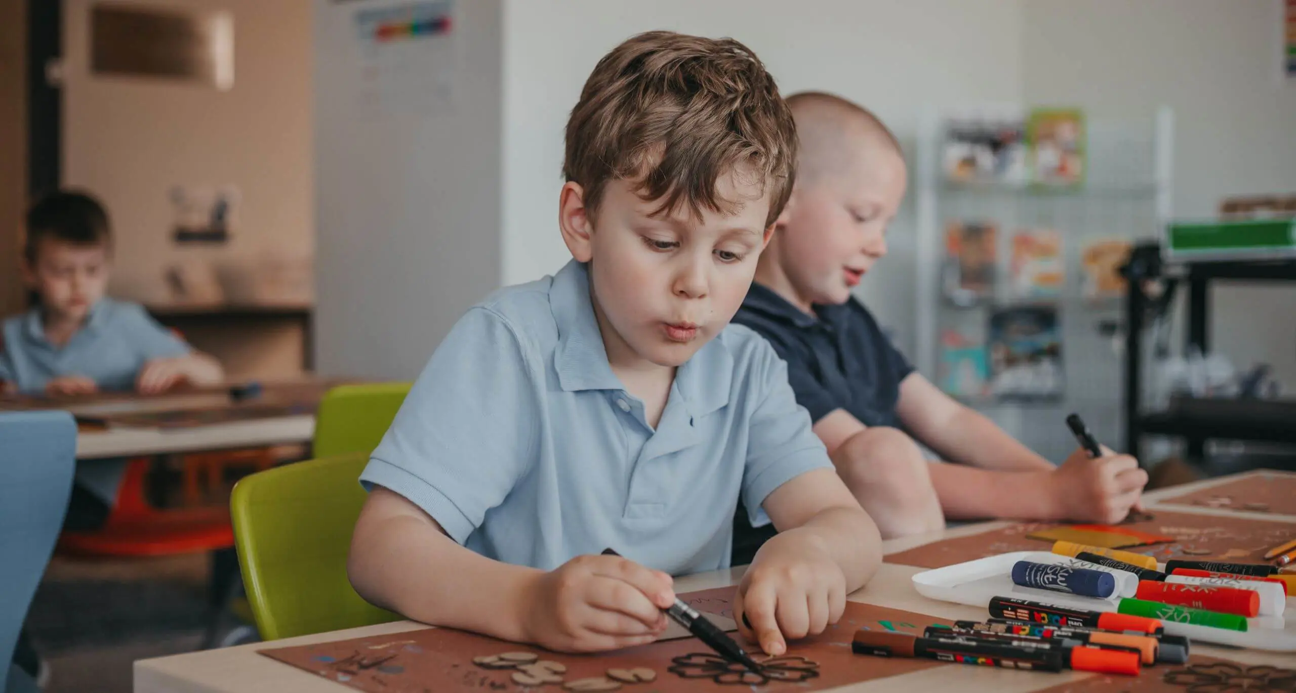 Young student creating an art project in the classroom.