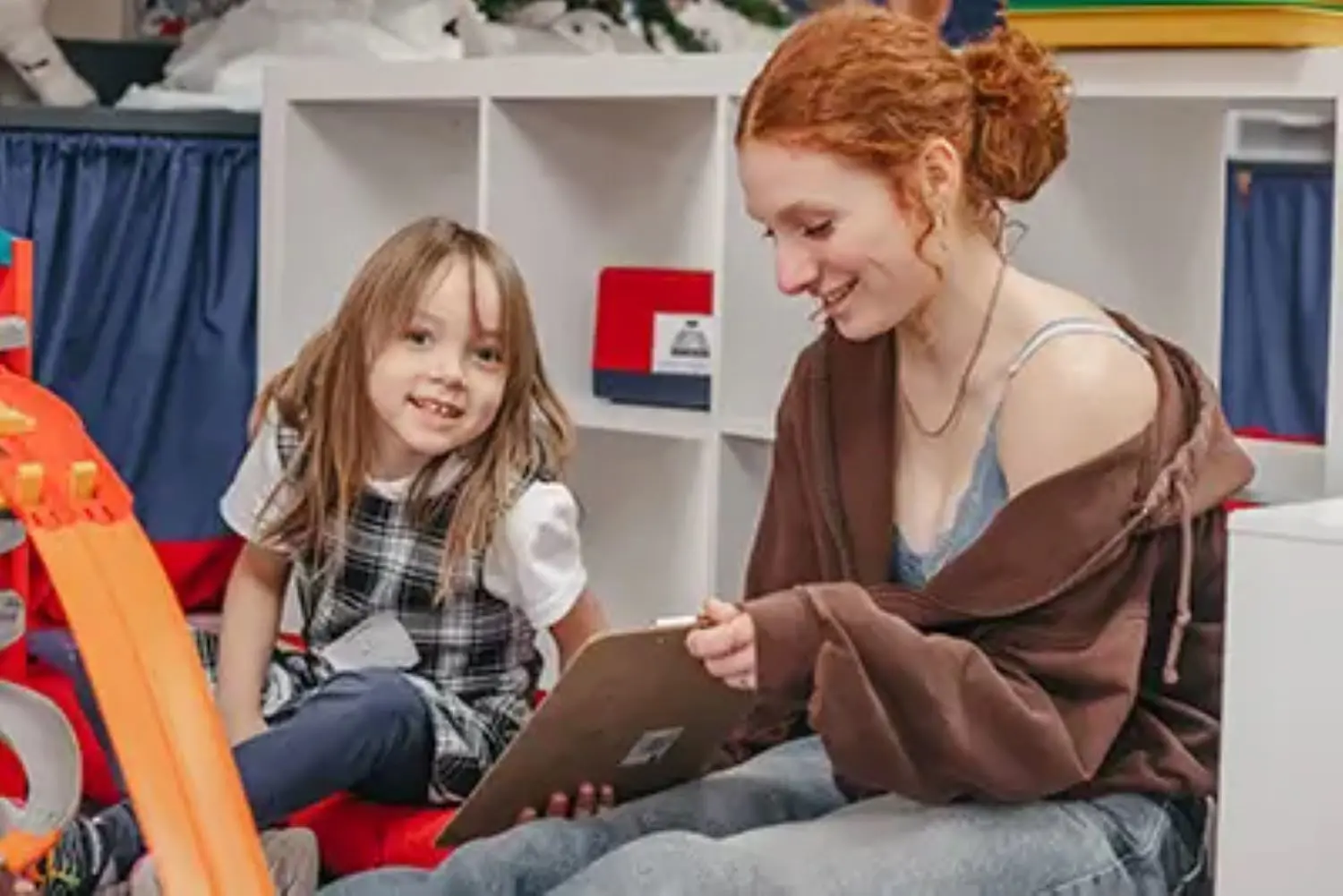 Upper School student reading to a kindergartner