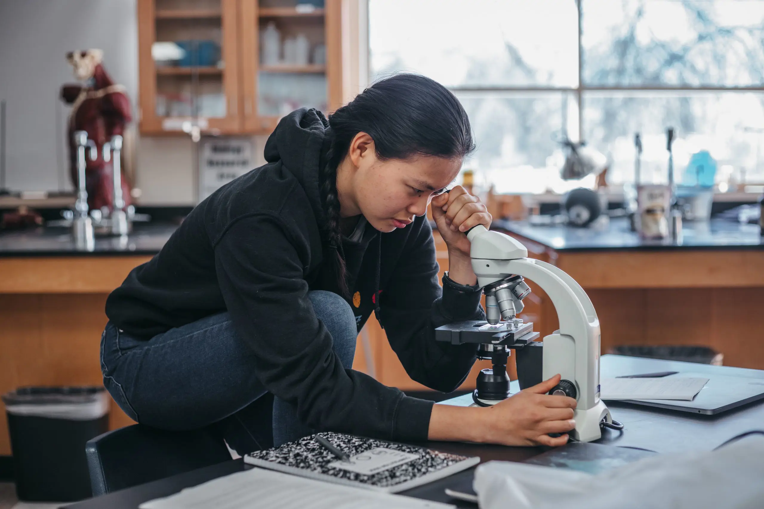 Student looking through a microscope
