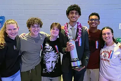 Students holding a trophy