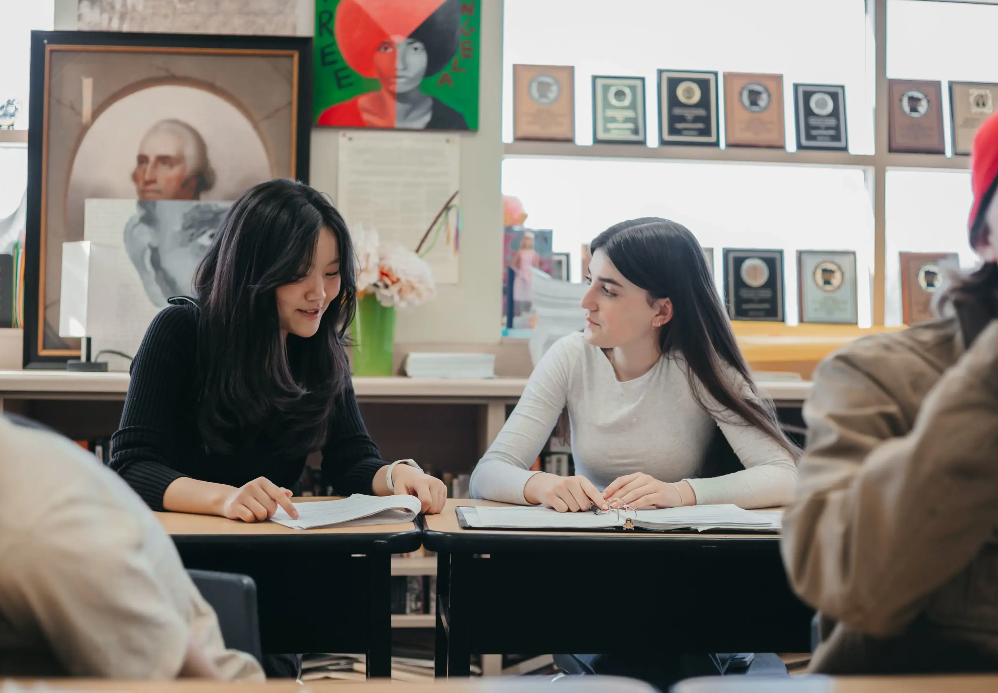 Students discussing coursework in a classroom