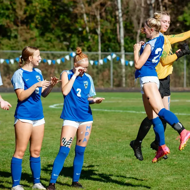 Students celebrating during a soccer match