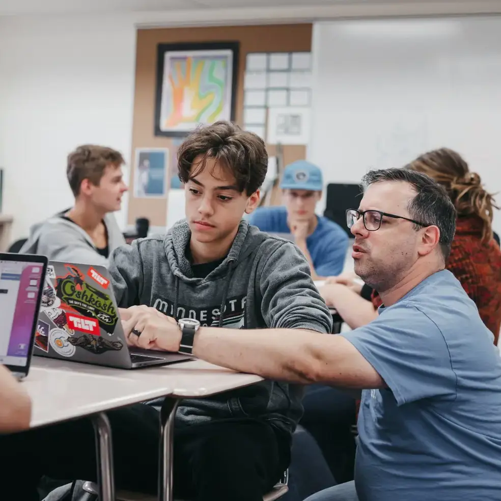 Teacher helping student during a lesson