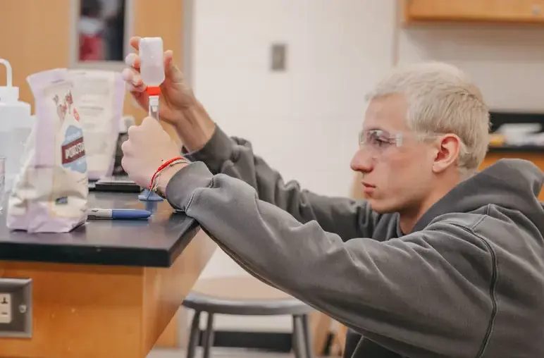 Students measuring liquids during a science activity