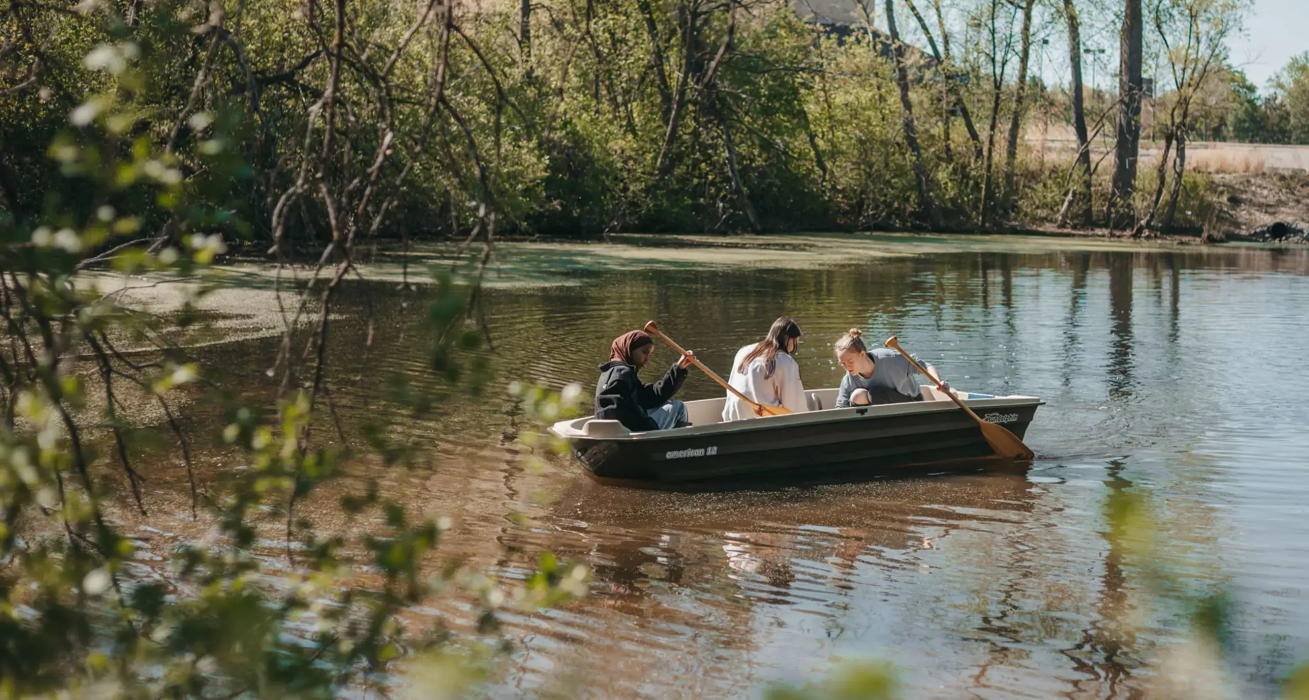 Students exploring a lake during an outdoor learning experience