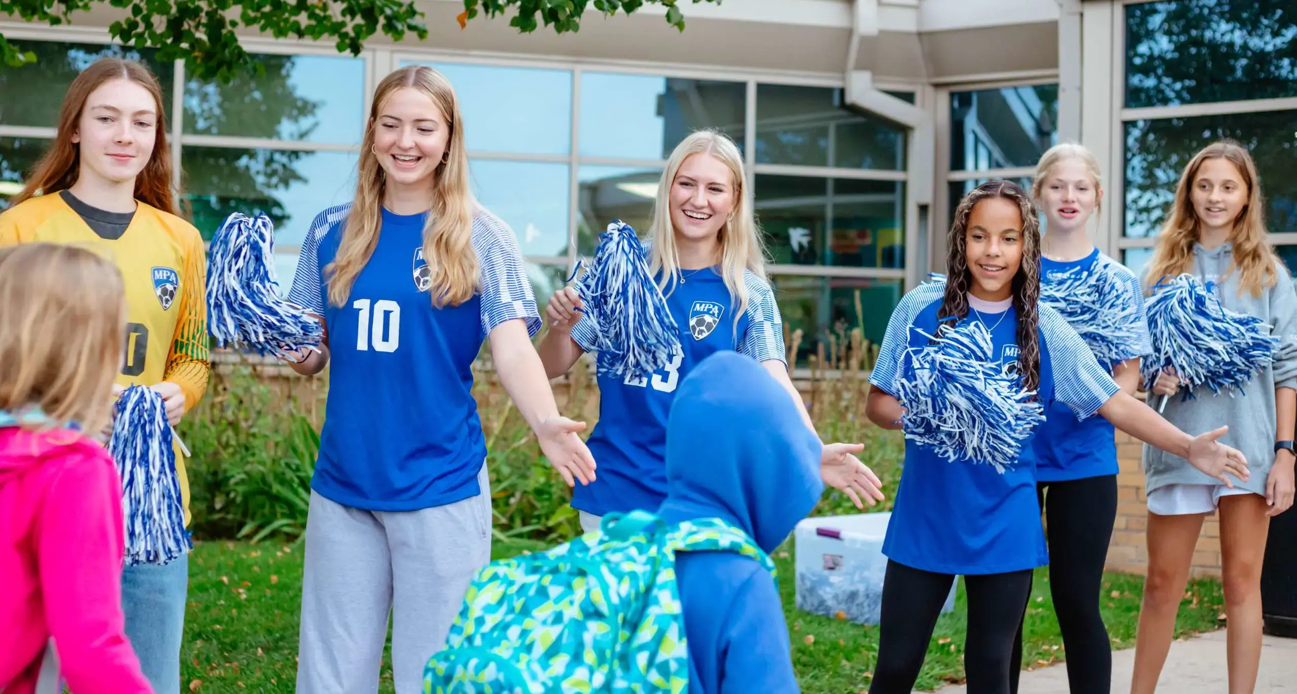 Upper School students welcoming younger students to campus.