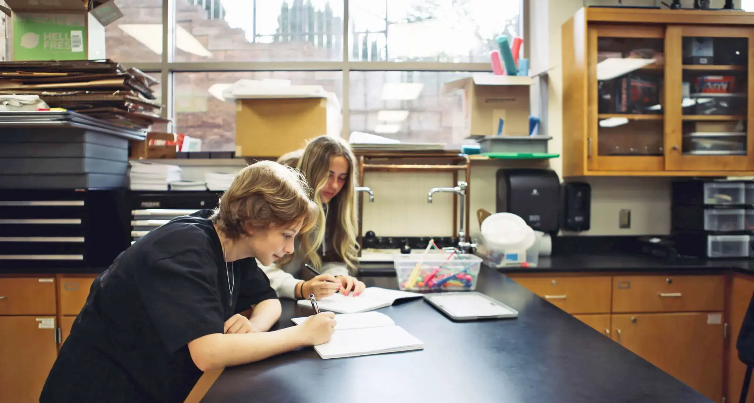 Students writing on a notebook