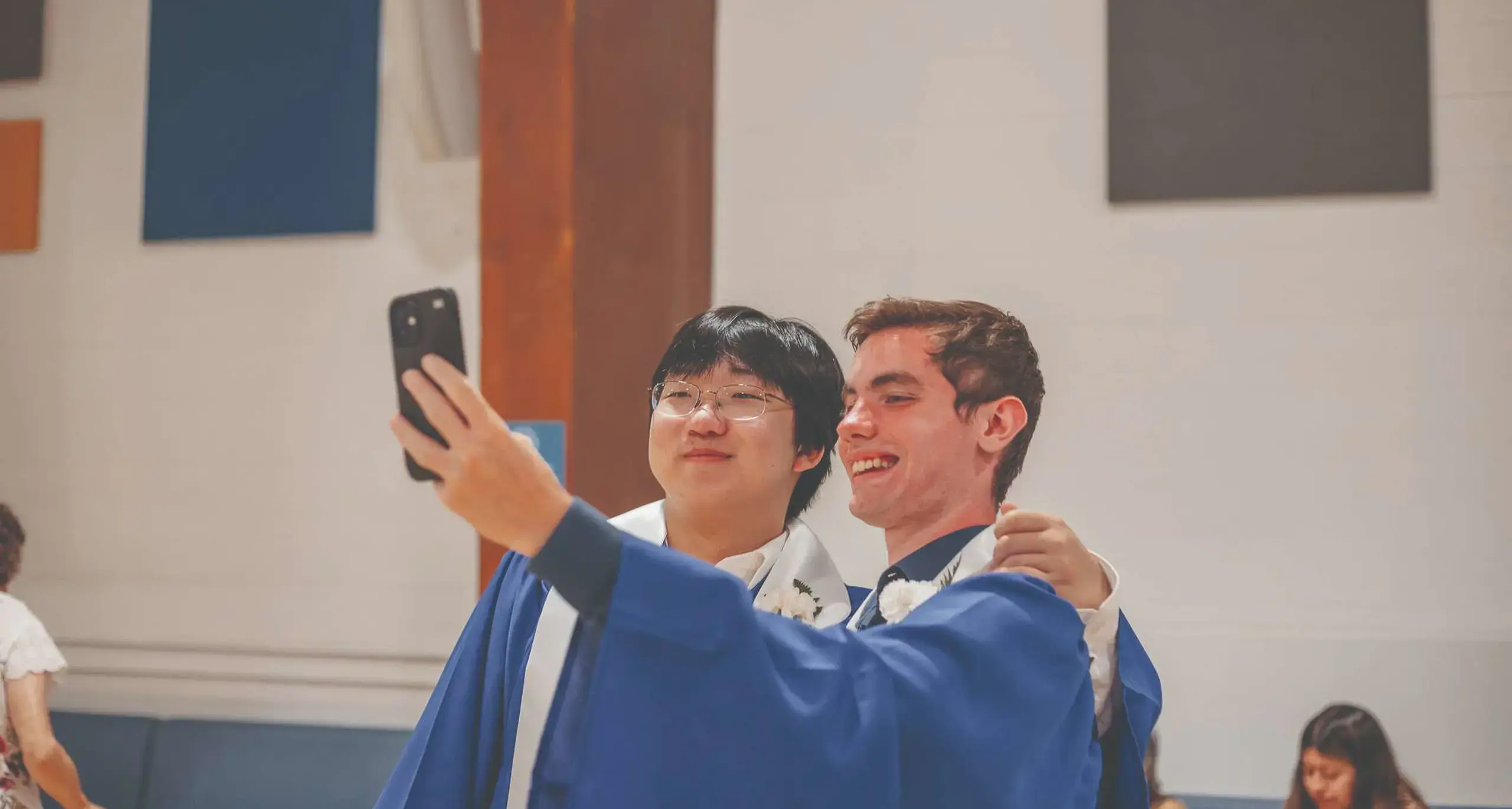 Graduates taking a selfie together
