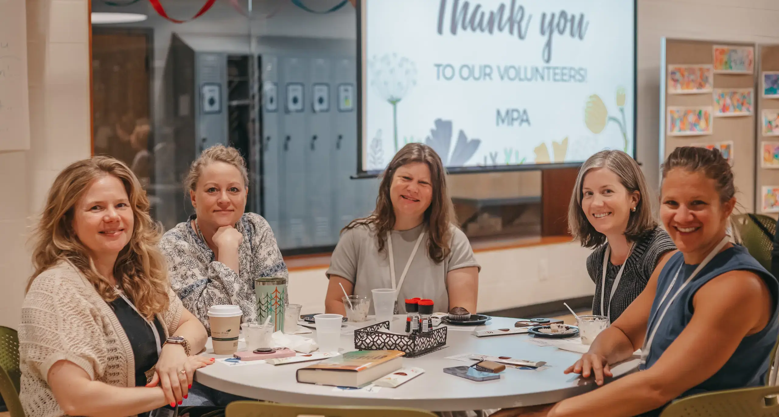Volunteers gathered at a school appreciation breakfast