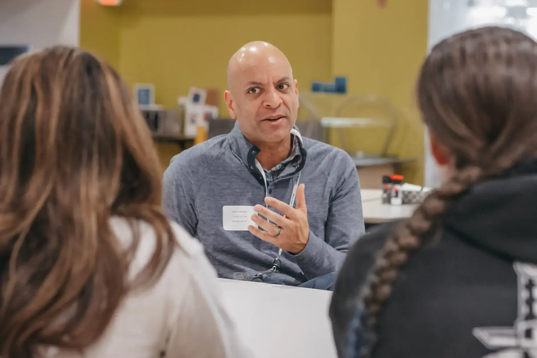 Alumnus speaking with students during a mentoring session.