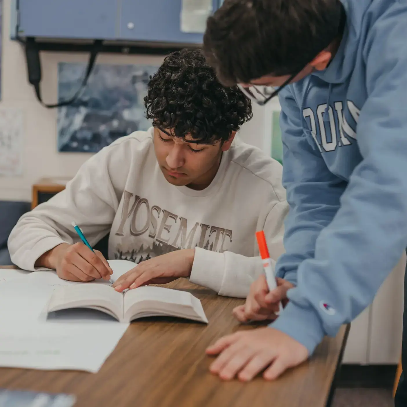 Student writing on a notebook