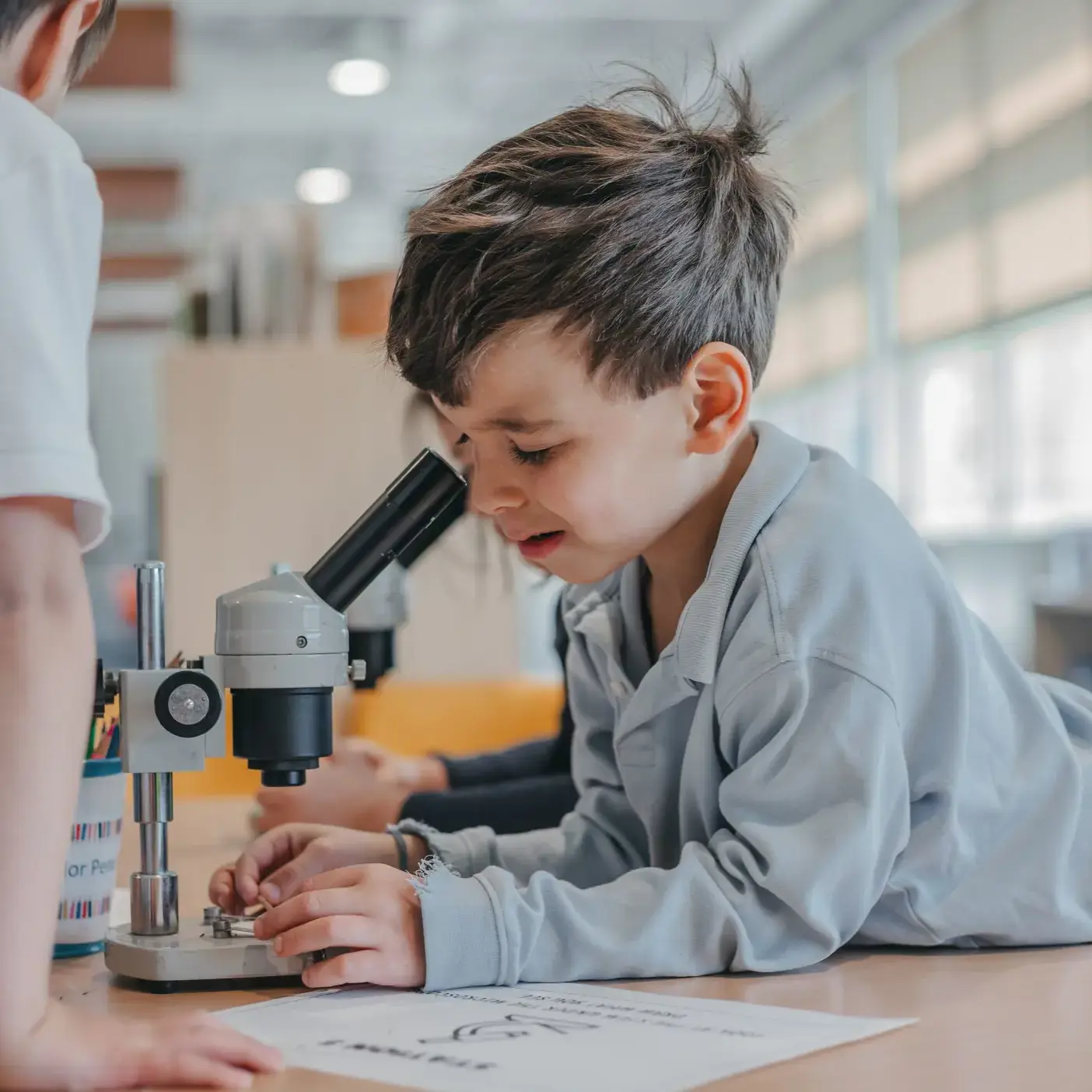Student looking through a microscope