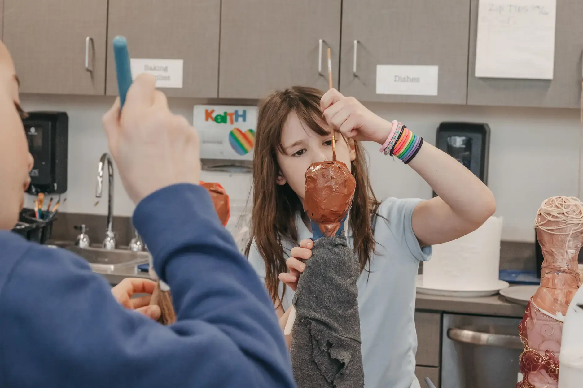 Students making artwork in arts class