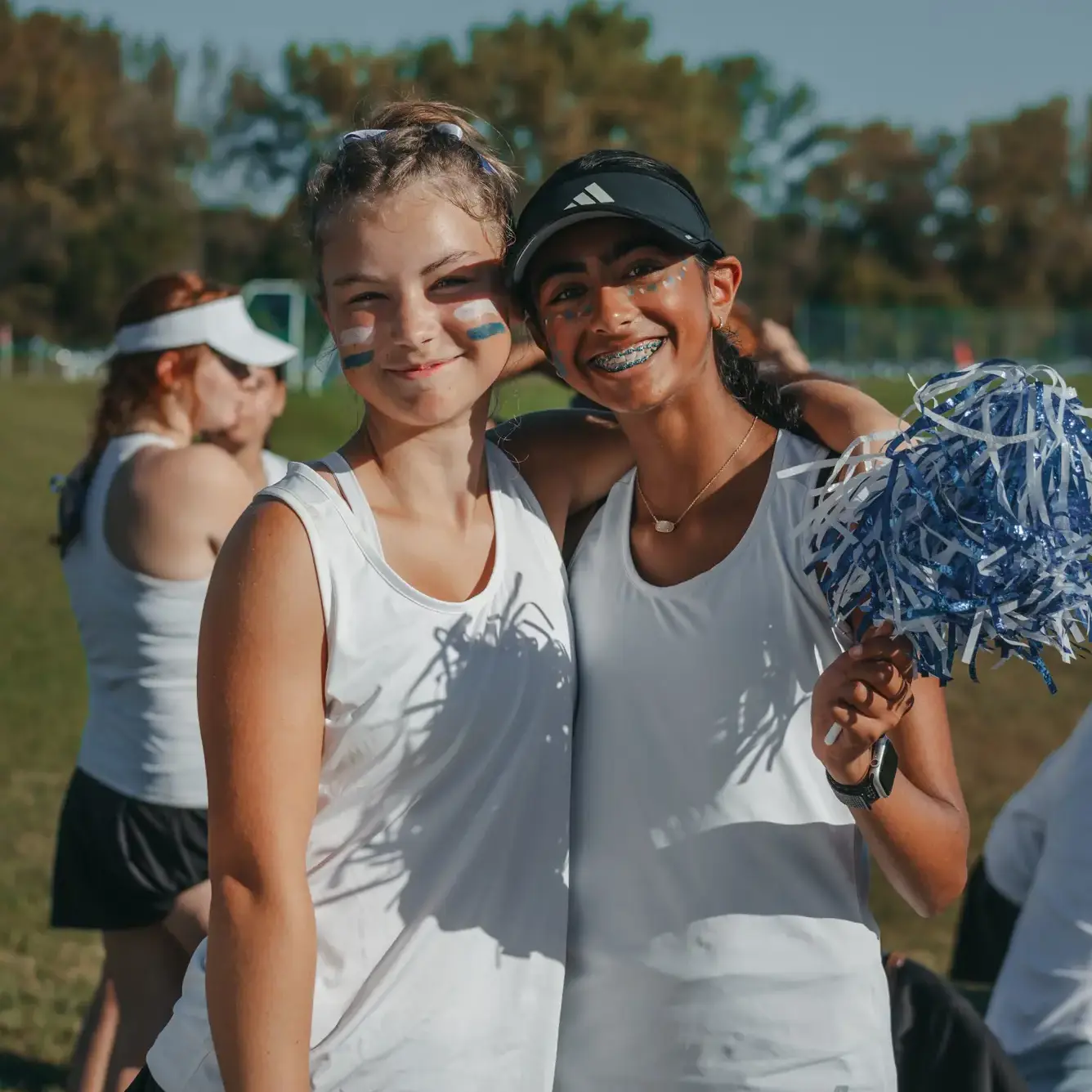 Students smiling during an outdoors activity