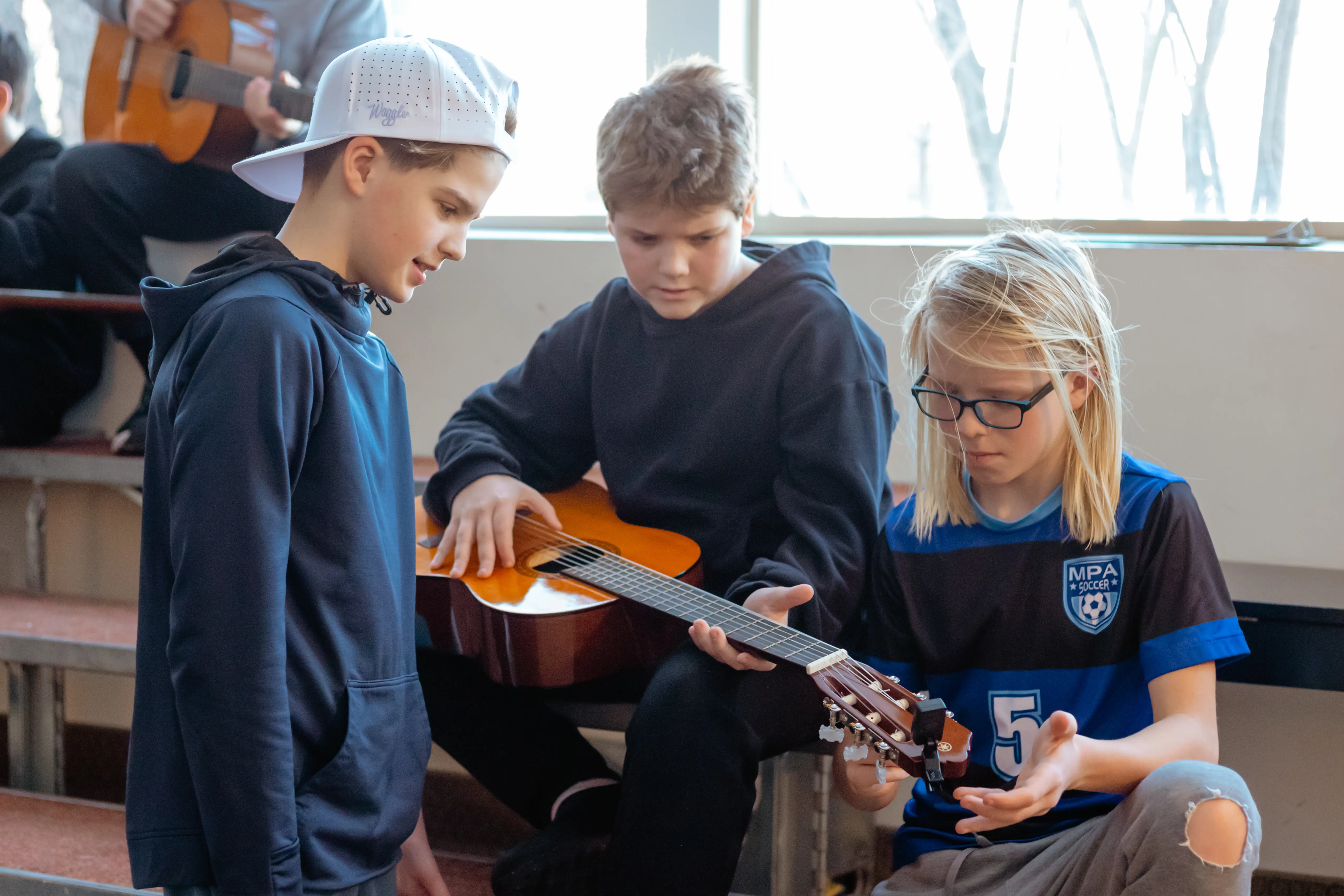 Students learning during a guitar lesson