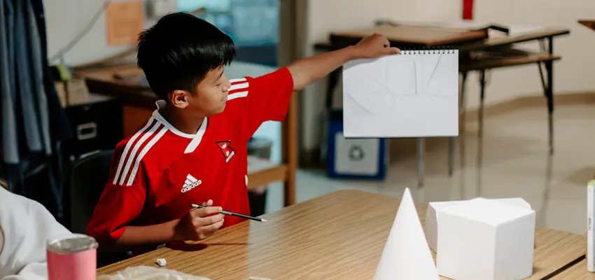 Student showing his drawing