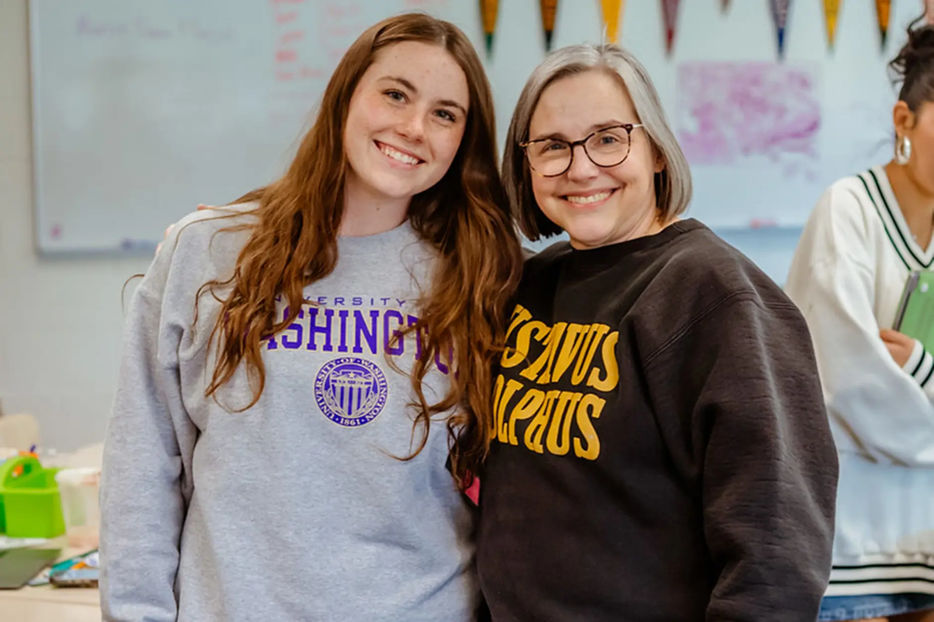 Teacher and student smiling together in the classroom.