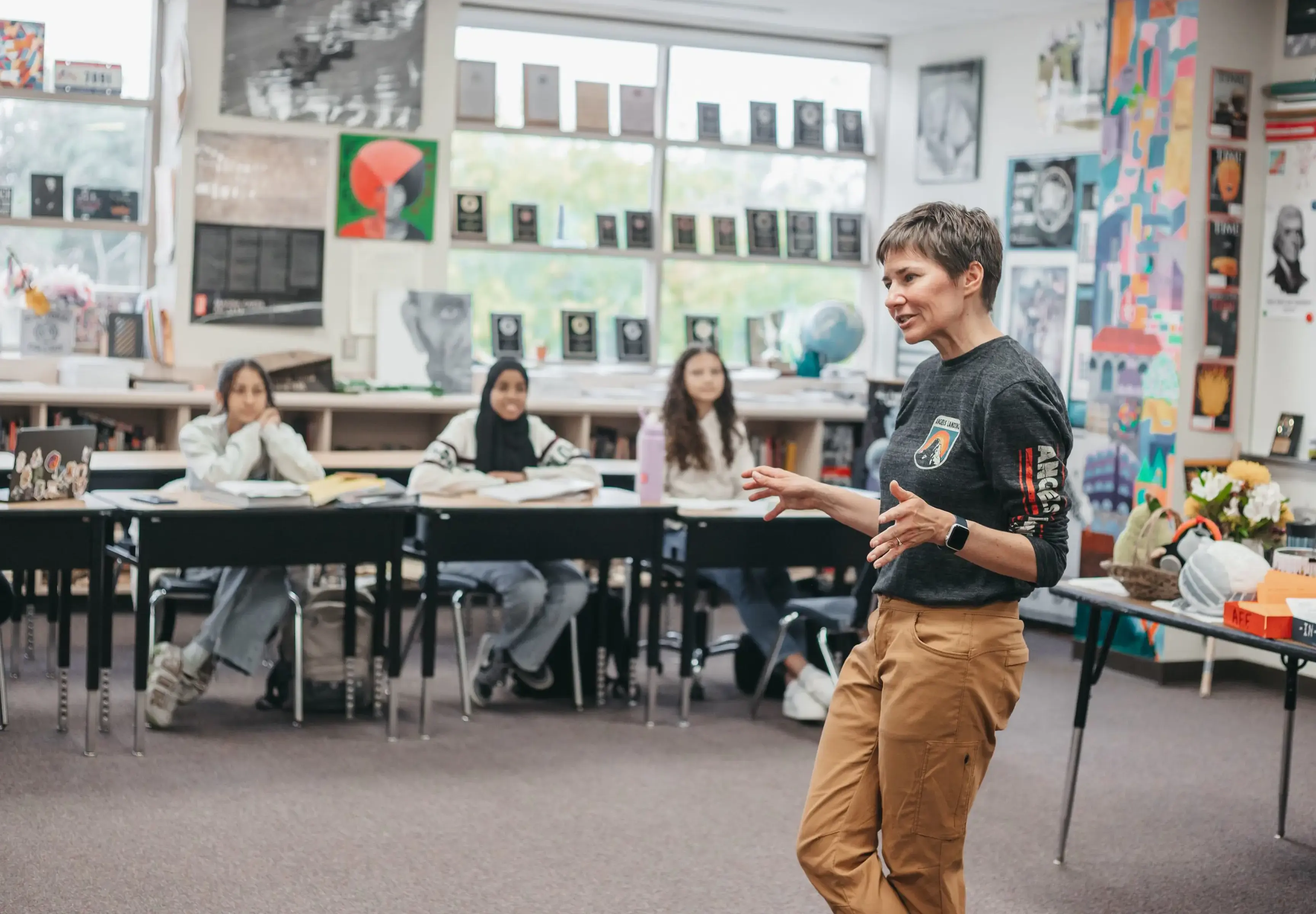 Teacher leading a discussion with students in a classroom.