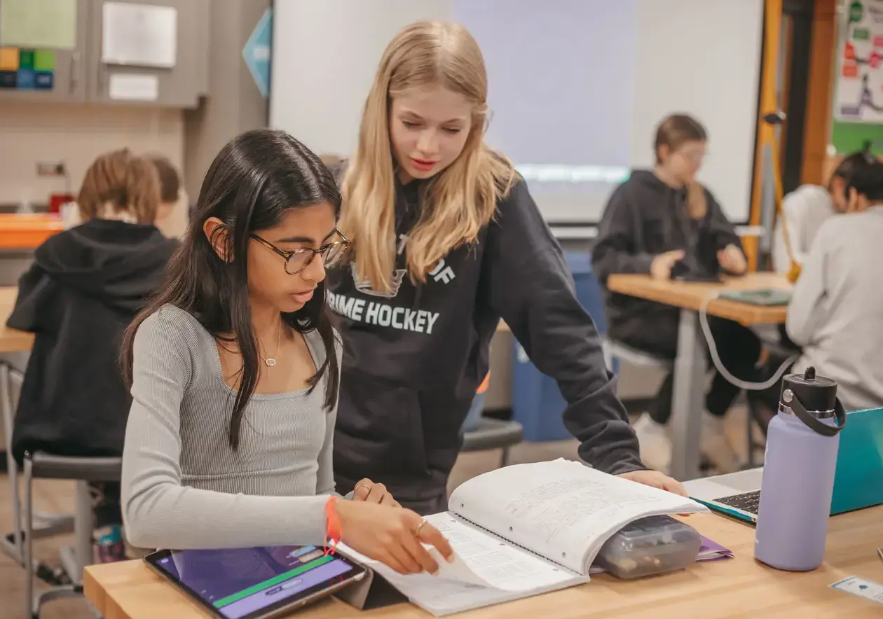 Students looking at a textbook