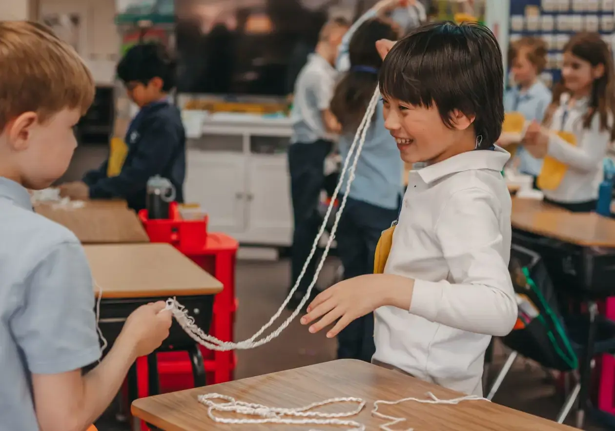 students playing with string