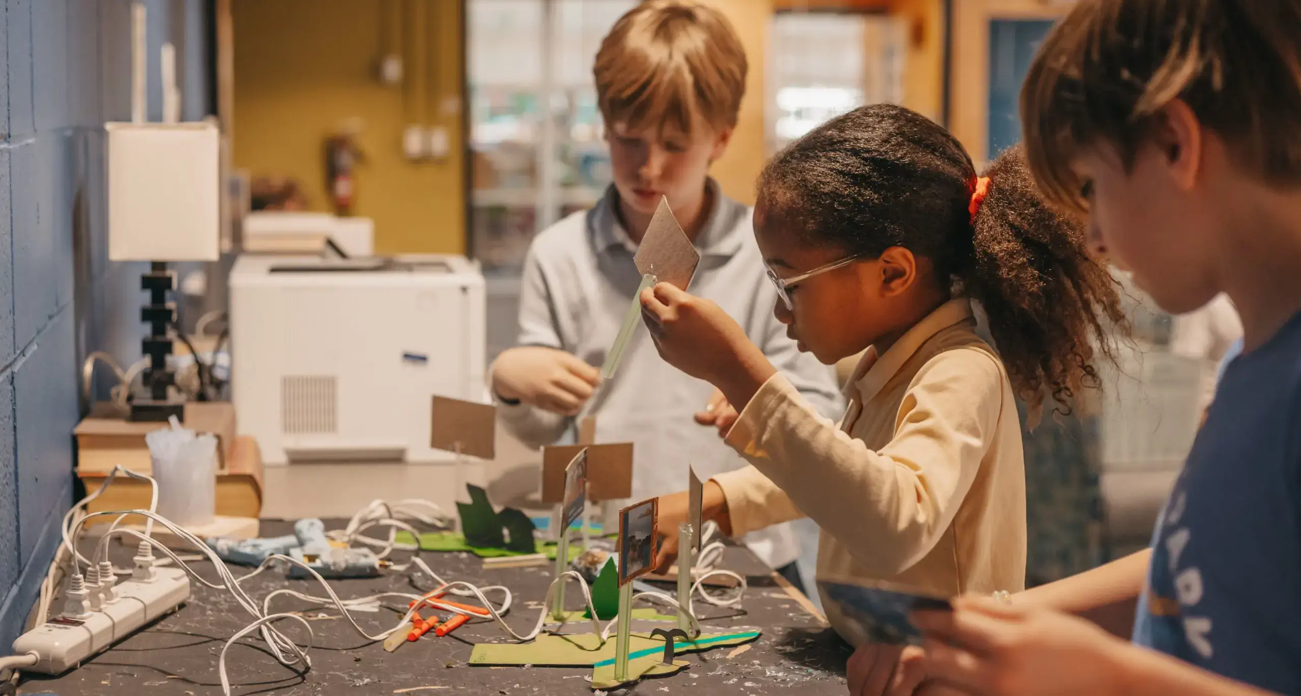 Lower school students building STEM projects together.