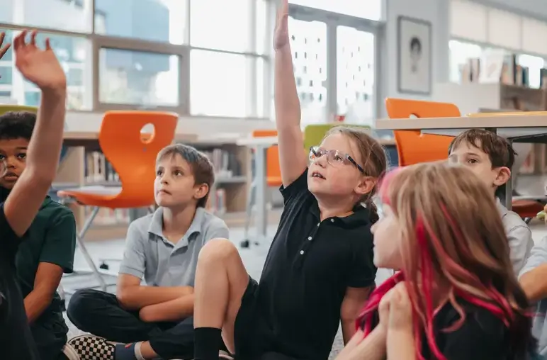 students raising their hands