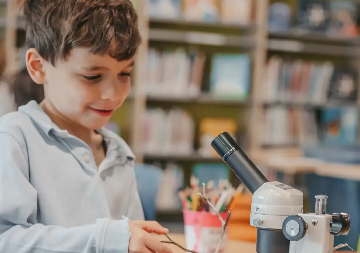 student looking through a microscope