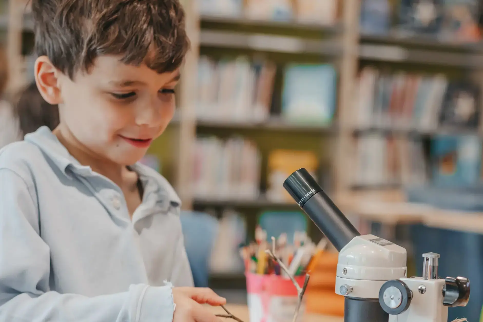 Student using a microscope in science class