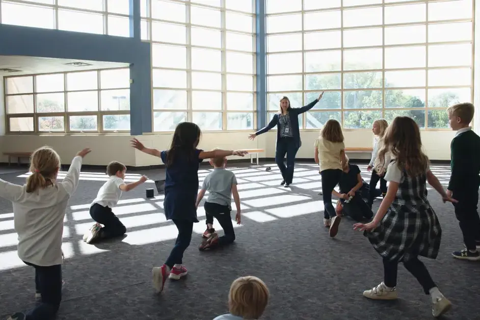 lower school students and teacher dancing together