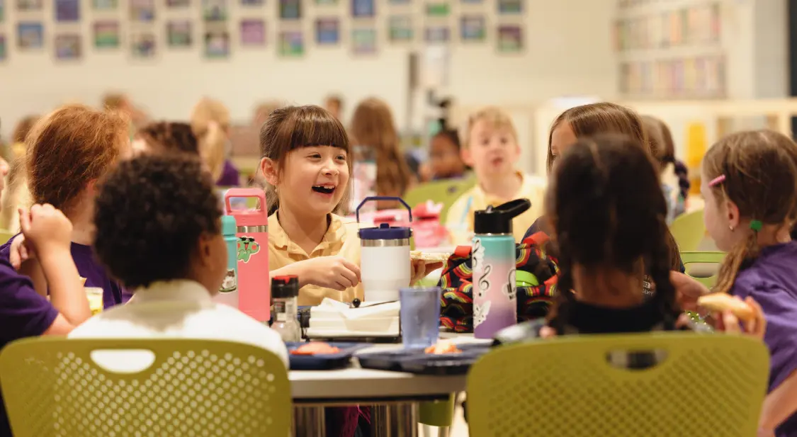 Students sitting at the table at luch time