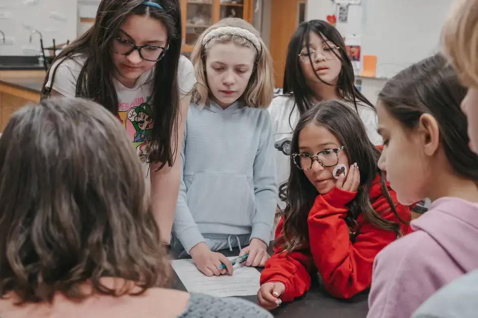 Middle school students engaging on a lesson with their teacher