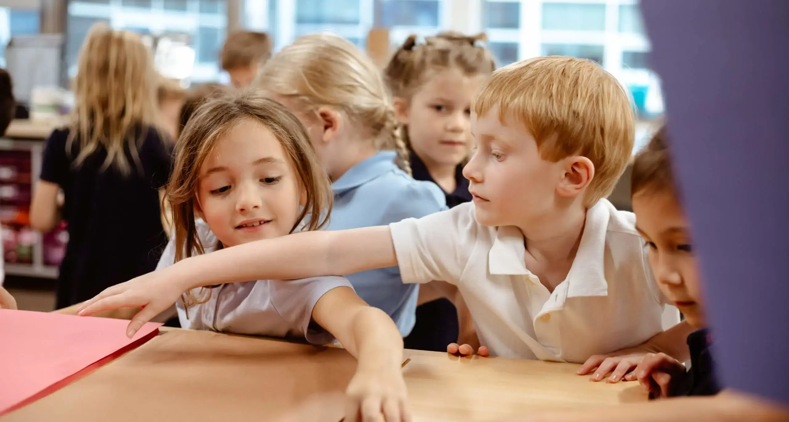 Young students collaborating on a classroom activity.